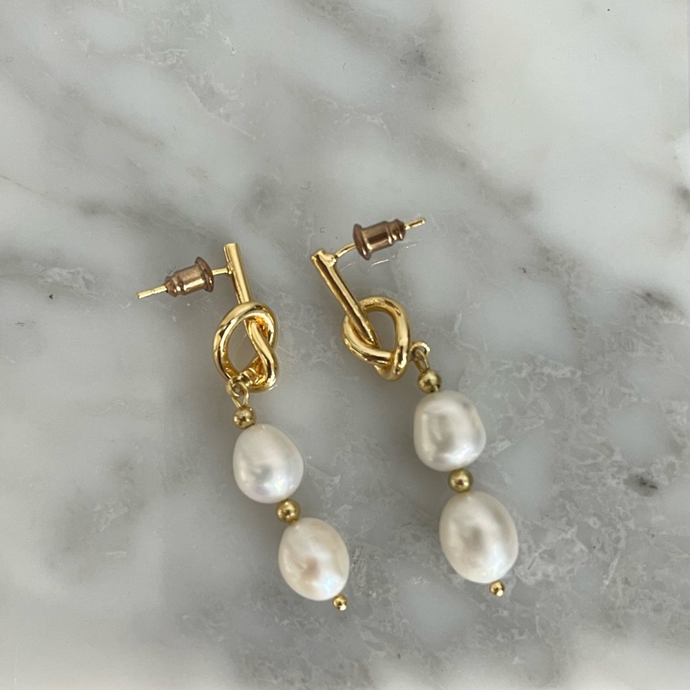 Real freshwater pearl earrings, held by a dainty gold knot, an elegant classic